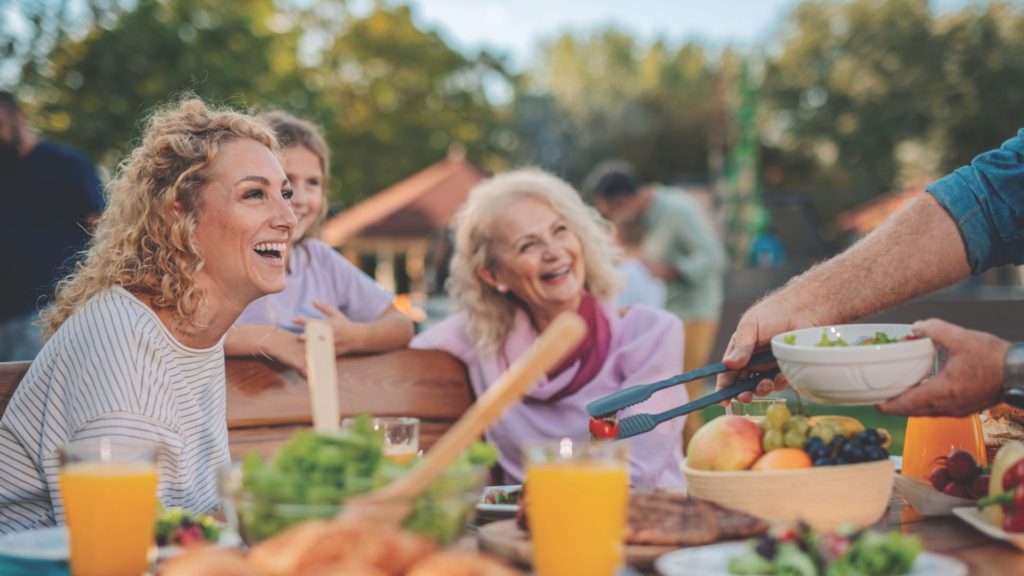Family enjoying an outdoor meal made with fresh, responsibly grown food.